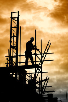 builder on scaffold building site