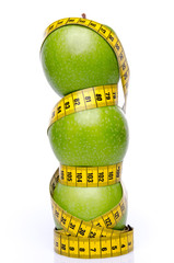 Stacked apples with a tape measure