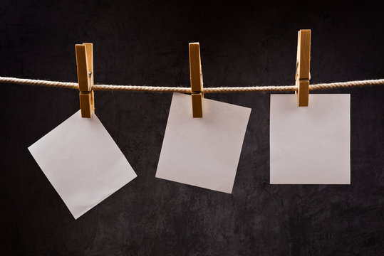 Three Blank paper notes hanging on rope with clothes pins