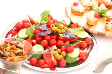 outdoor buffet with salads, appetizers, pickles, sandwiches