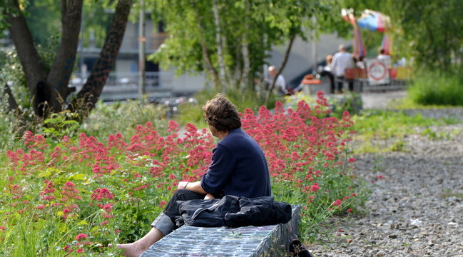 homme assis dans un jardin public