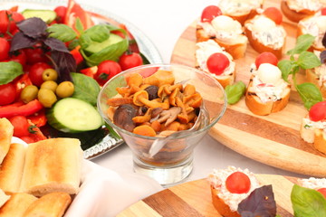 outdoor buffet with salads, appetizers, pickles, sandwiches