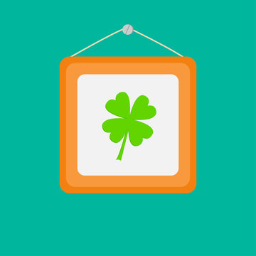 Four leaf clover and picture frame on the wall. Flat design.