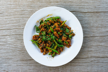 Pork sauteed with garlic and hot basil set on steamed rice