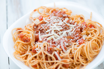 Close-up of spaghetti bolognese in a glass plate, studio shot