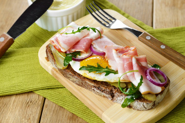 Bacon and fried eggs open sandwich