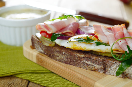 Bacon and fried eggs open sandwich
