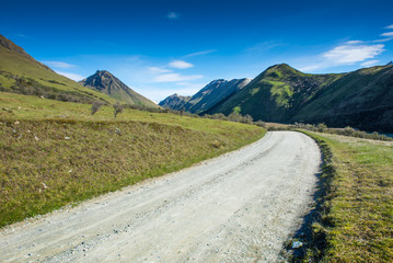 Landscape with dirt road in the mountains , New Zealand