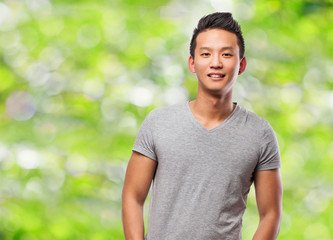 handsome young asian man smiling at park