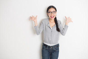 asian young female student smiling with plain background