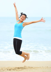 cheering woman jumping on  beach