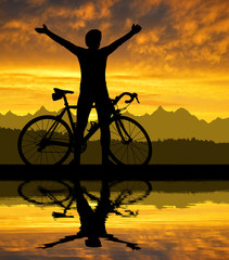 Fototapeta na wymiar Silhouette of the cyclist on road bike at sunset