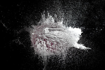  explosions of water balloons hit by a bullet. frozen action from high speed photography. concept of fragility and time.