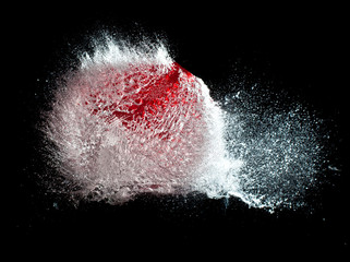  explosions of water balloons hit by a bullet. frozen action from high speed photography. concept of fragility and time.