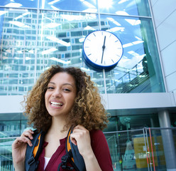 Young woman smiling outside station