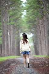 Girl on the rain in pine forest