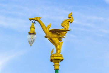 Fototapeta na wymiar golden swan on street light post