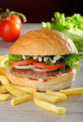 Big juicy gourmet burger with chips