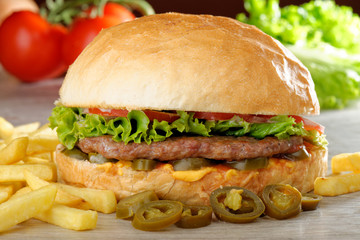 Big juicy Mexican burger with spicy jalapenos, nacho cheese