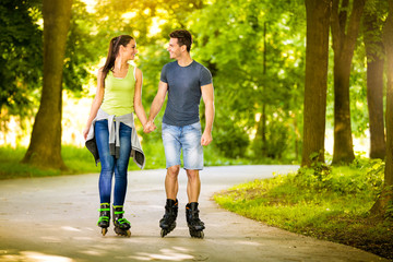 Love couple spending free time  together on roller