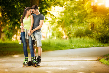 Love couple ride rollerblades in the park