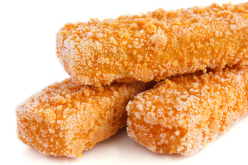 Single frozen bread crumbed fish finger on white