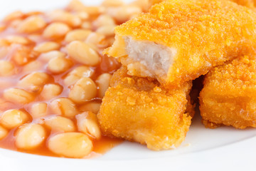 Plate of baked beans with fried fishfingers