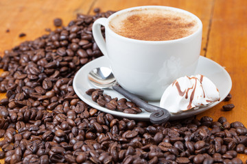 Freshly brewed cup of coffee served with meringue