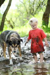 Young Child and Dog Playing in Muddy River © Christin Lola