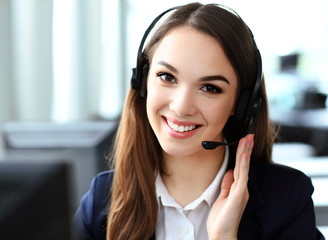 Female customer support operator with headset and smiling 