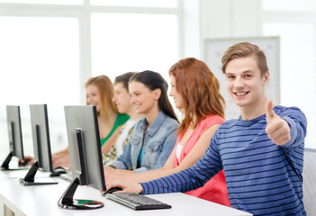 male student with classmates in computer class