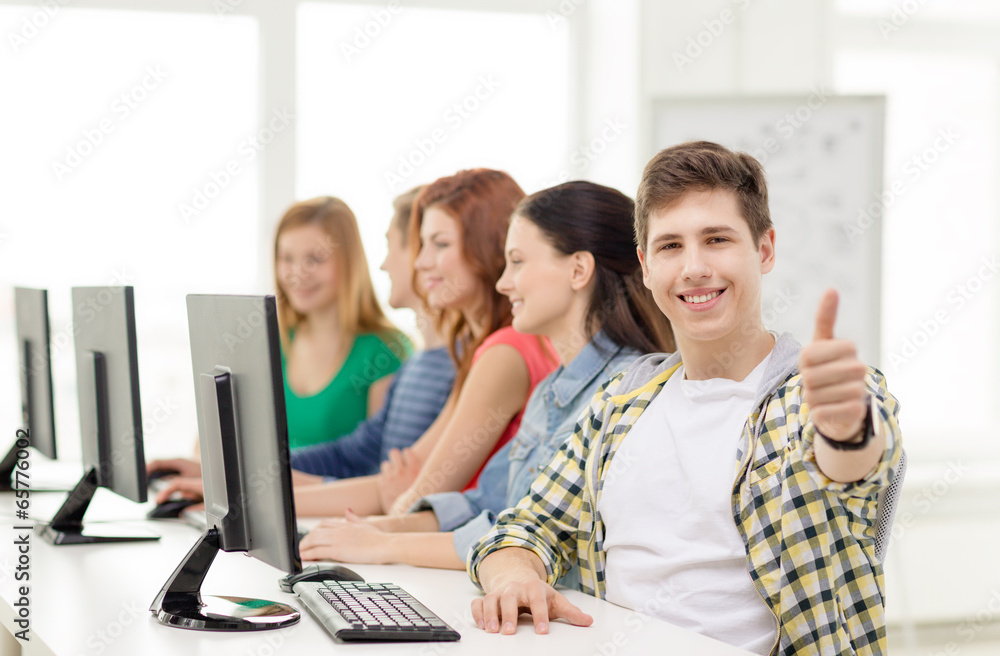 Wall mural male student with classmates in computer class