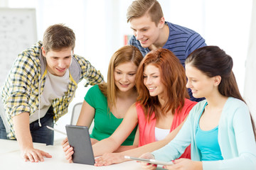 smiling students with tablet pc at school