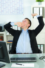 gähnender mann im büro