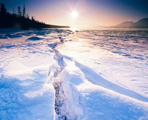 Fotobehang Sunny frozen Tagish Lake ice crack Yukon Canada © PiLensPhoto
