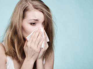 Flu allergy. Sick girl sneezing in tissue. Health