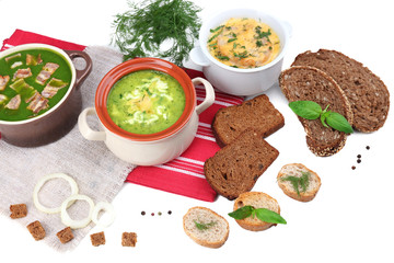 Obraz na płótnie Canvas Tasty soup in saucepans, isolated on white