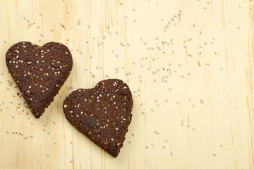 Chia seed love heart cookies on wooden background