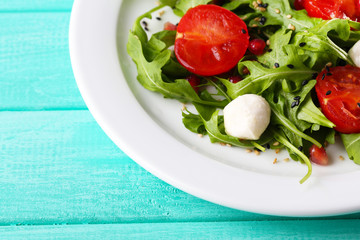 Green salad made with  arugula, tomatoes, cheese mozzarella
