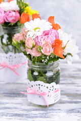 Beautiful bouquet of bright flowers in jars