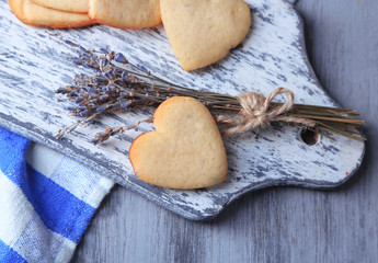 Lavender cookies on cutting board, on color napkin background