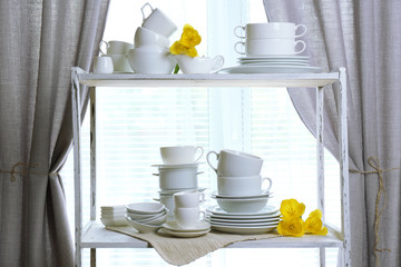Different tableware on shelf in the interior