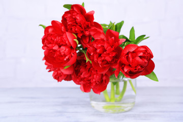 Beautiful pink peonies on grey wall background