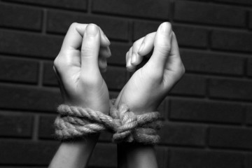 Tied hands in shades of grey