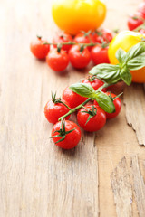 Fresh cherry tomatoes on old wooden table