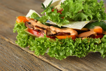 Veggie wrap filled with chicken and fresh vegetables