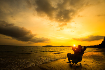 Relaxing businessman sitting on beach