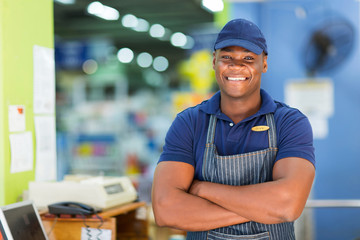 african supermarket cashier standing at checkout