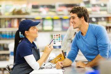 paint store assistant helping customer choose paint color