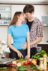  loving couple hugging in the kitchen